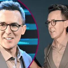Maciej Kurzajewski w garniturze i okularach, uśmiecha się.