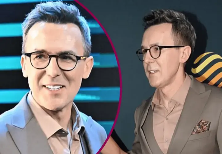 Maciej Kurzajewski w garniturze i okularach, uśmiecha się.